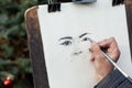 Lviv, Ukraine - January 2, 2020: Street Artist Draws Sketch Portrait of a beautiful girl
