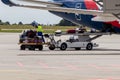 Airport staff unload luggage from a plane