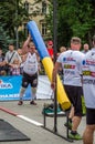 LVIV, UKRAINE - JULY 2016: Mighty strong athlete bodybuilder strongman lifting heavy iron pipe in the street in front of