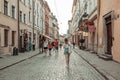 People tourists walking down the street of rynok square in old city center of Lviv on a summer sunny day Royalty Free Stock Photo