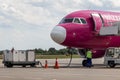 Plane Wizz Air at airport while refueling