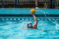 Lviv, Ukraine - July 2015: Ukrainian Cup water polo. Athlete team's water polo ball in a swimming pool and makes attacking shot on Royalty Free Stock Photo