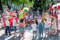 Lviv, Ukraine - July 2015: Yarych street Fest 2015. Clown and Indian play, sing and dance with the children in the park Royalty Free Stock Photo