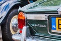 Closeup rear view of old vintage bottle green Jaguar XJ12 car