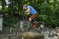 LVIV, UKRAINE - JUNE 2018: A cyclist performs tricks on a bicycle trial to overcome an obstacle course