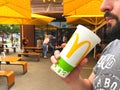 Lviv, Ukraine - June 15, 2020 : man drinking juice or cola during lunch at McDonald`s restaurant, sitting on the open air terrace