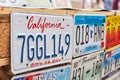 Old discontinued car license plates or vehicle registration numbers from different USA states such as California, Texas Royalty Free Stock Photo