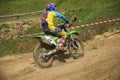 Motorcycle racer overcomes motocross track Royalty Free Stock Photo