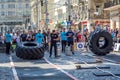 LVIV, UKRAINE - JUNE 2016: A strong man in the sports form bodybuilder raises heavy wheel on the street
