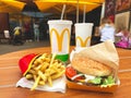 Lviv, Ukraine - June 15, 2020 : tasty lunch at McDonald`s restaurant on wooden table - delicious burger with fresh vegetables,