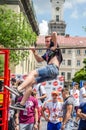 LVIV, UKRAINE - JUNE 2016: Young boy athlete demonstrates his ability by performing different exercises and figures on the horizon Royalty Free Stock Photo