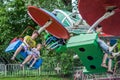 LVIV, UKRAINE - JUNE 2016: Young father with his daughter ride on the carousel in an amusement park, with joyful happy emotions