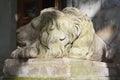 Marble sculpture of lion with coat of arms.