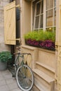 Lviv, Ukraine. March 2020. Decorative Bicycle on the street of the old city at the window with wooden shutters Royalty Free Stock Photo