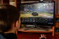 LVIV, UKRAINE - MARCH 08, 2019: Illustration of a computer game World of Tanks, showing a teenager playing this game