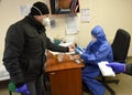 Lviv, Ukraine - March 31, 2020: A medical worker makes a rapid test for coronavirus COVID-19 of a bus driver in Lviv, Ukraine