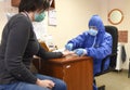 Lviv, Ukraine - March 31, 2020: A medical worker makes a rapid test for coronavirus COVID-19 of a municipal employee in Lviv,