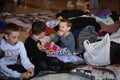 Ukrainian refugees on Lviv railway station during russian war. Refugee kids in waiting hall