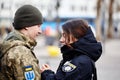 Lviv, Ukraine - March 9, 2022. Ukrainian soldier at the railway station in Lviv, embraces his girlfriend before heading to the