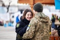Lviv, Ukraine - March 9, 2022. Ukrainian soldier at the railway station in Lviv, embraces his girlfriend before heading to the