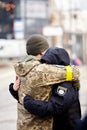 Lviv, Ukraine - March 9, 2022. Ukrainian soldier at the railway station in Lviv, embraces his girlfriend before heading