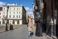 LVIV,UKRAINE, 22 March 2020: beautiful young European woman walking empty street wearing disposable protective face mask during