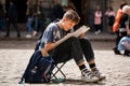 LVIV UKRAINE - May 17, 2019: Boy create outdoors sketches. Learner paint the urban landscape of the old European city