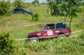 LVIV, UKRAINE - MAY 2016: Huge tuned car Jeep SUV driving on a dirt road rally, raising a cloud of dust behind, among the Royalty Free Stock Photo