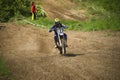 Motorcycle racer overcomes motocross track Royalty Free Stock Photo