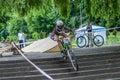 LVIV, UKRAINE - MAY 2016: The sportsman on a bicycle helmet is racing at high speed bouncing jumping competition during downhill