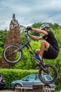 LVIV, UKRAINE - MAY 2016: The sportsman on a bicycle helmet is racing at high speed bouncing jumping competition during downhill