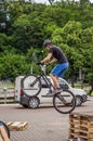 LVIV, UKRAINE - MAY 2016: The sportsman on a bicycle helmet is racing at high speed bouncing jumping competition during downhill