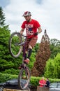 LVIV, UKRAINE - MAY 2016: The sportsman on a bicycle helmet is racing at high speed bouncing jumping competition during downhill