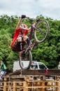 LVIV, UKRAINE - MAY 2016: The sportsman on a bicycle helmet is racing at high speed bouncing jumping competition during downhill