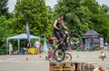 LVIV, UKRAINE - MAY 2016: The sportsman on a bicycle helmet is racing at high speed bouncing jumping competition during downhill