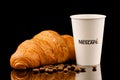 LVIV, UKRAINE - November 26, 2020: Nescafe coffee in a paper cup and croissant Royalty Free Stock Photo