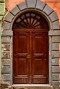Lviv, Ukraine - November, 2017. An old large wooden door with a bronze handle in the center of Lviv. The door made of wood is trea