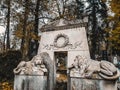 Lviv / Ukraine - November 2019: Tombstone and lion sculptures in a crypt outdoor at Lychakiv cemetery. Famous old graveyard in