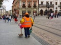 Lviv, Ukraine - oct 7 2018: An employee of the communal economy in the central square Market of the old town. Ancient architecture