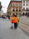 Lviv, Ukraine - oct 7 2018: An employee of the communal economy in the central square Market of the old town. Ancient architecture