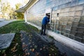 Lviv, Ukraine - October 09, 2022: Elderly man inserting credit card to ATM