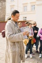 Lviv, Ukraine. A guide in a beggar costume on an animated tour in a historic city