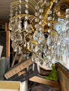 Lviv, Ukraine - September 7, 2021 : Antique brass chandelier with crystal almonds and other vintage goods on flea market