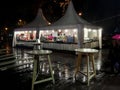 A street cafe in the form of a tent in the rain