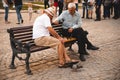 Lviv, Ukraine - September 18, 2018: two old seniors men plays chess outdoors at city bench Royalty Free Stock Photo