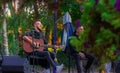 Lviv, Ukraine - 09,26,2021 - street musician male person with guitar outdoor park land space, young culture