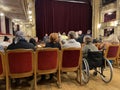 Lviv, Ukraine - 02 11 2023: woman sitting in a wheelchair is interested in watching ballet performance in theatre hall