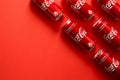 Lvov, Ukraine - January 23, 2018. Close-up of Coca Cola drink jars lying on paper background. Texture. Top view Royalty Free Stock Photo