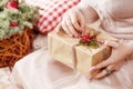 LWoman`s hands holding gift box. Christmas, new year, birthday concept. Festive background with bokeh and sunlight. Magic fairy