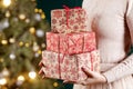 LWoman`s  hands holding gift boxes. Christmas, new year, birthday concept. Festive background with bokeh and sunlight. Magic fair Royalty Free Stock Photo